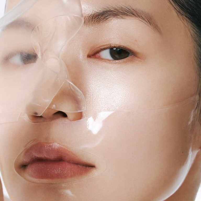 Model wearing a transparent Abib Glow Collagen Mask Glutathione Film on her face for radiant skin