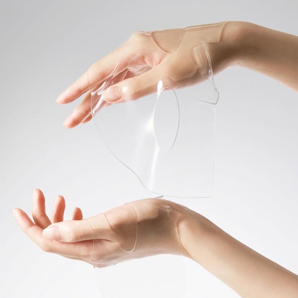 bareskin.lt Abib Glow Collagen Mask Glutathione Film, a transparent gel facial sheet mask held by two hands.