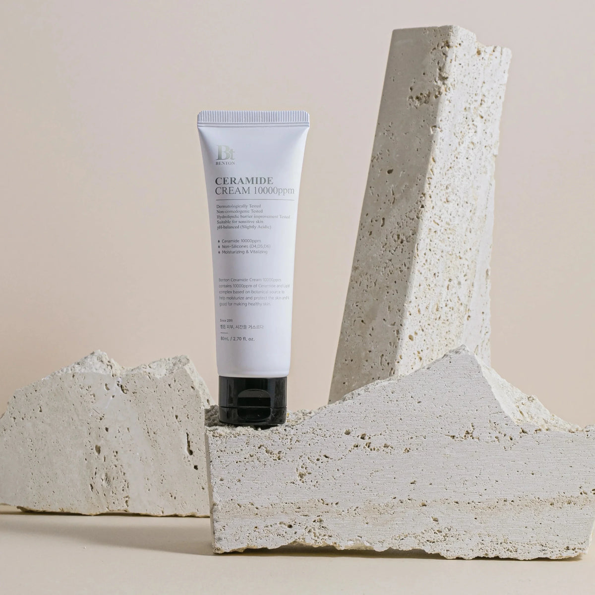 bareskin.lt Benton Ceramide Cream 10000ppm in a white tube displayed between textured stone blocks