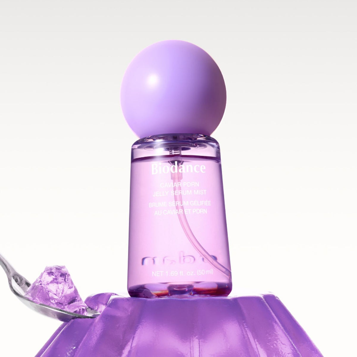 bareskin.lt Biodance Caviar PDRN Jelly Serum Mist in a purple bottle resting on purple jelly with a spoon