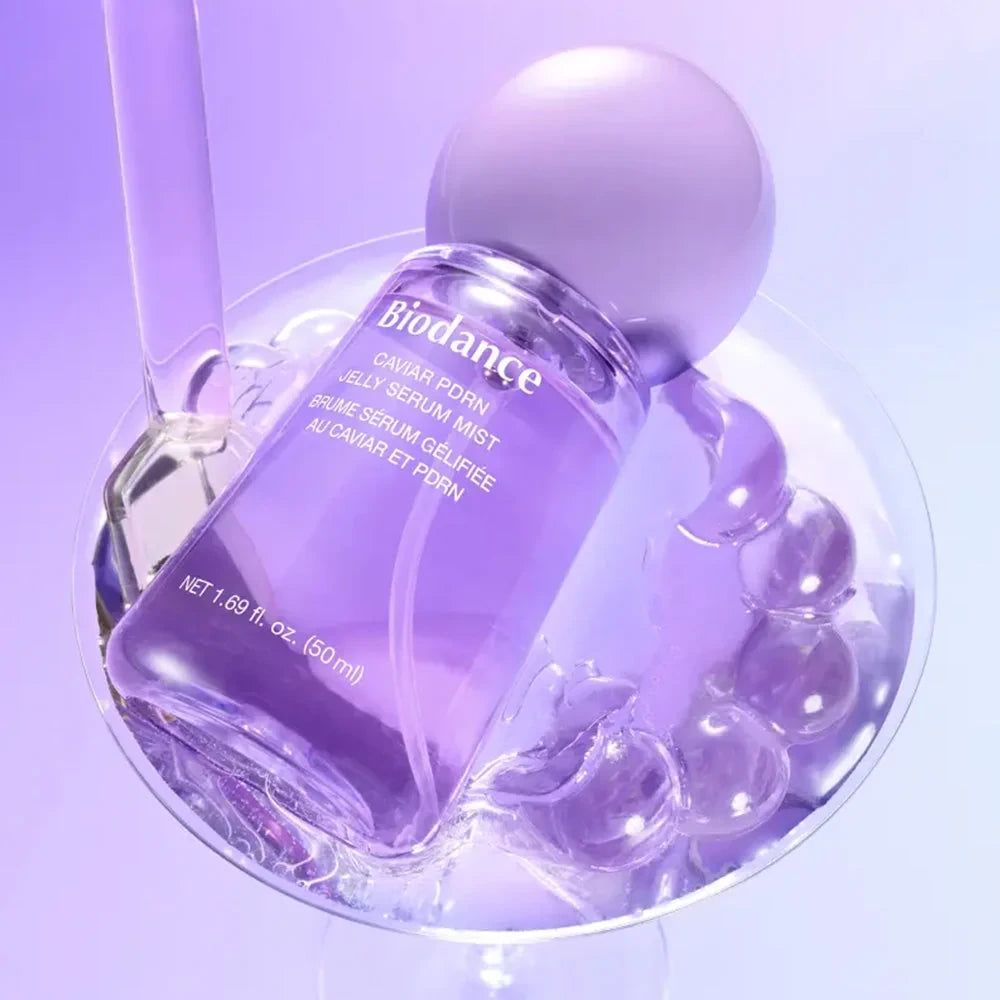 bareskin.lt Biodance Caviar PDRN Jelly Serum Mist in a purple glass bottle resting in a crystal bowl with water beads