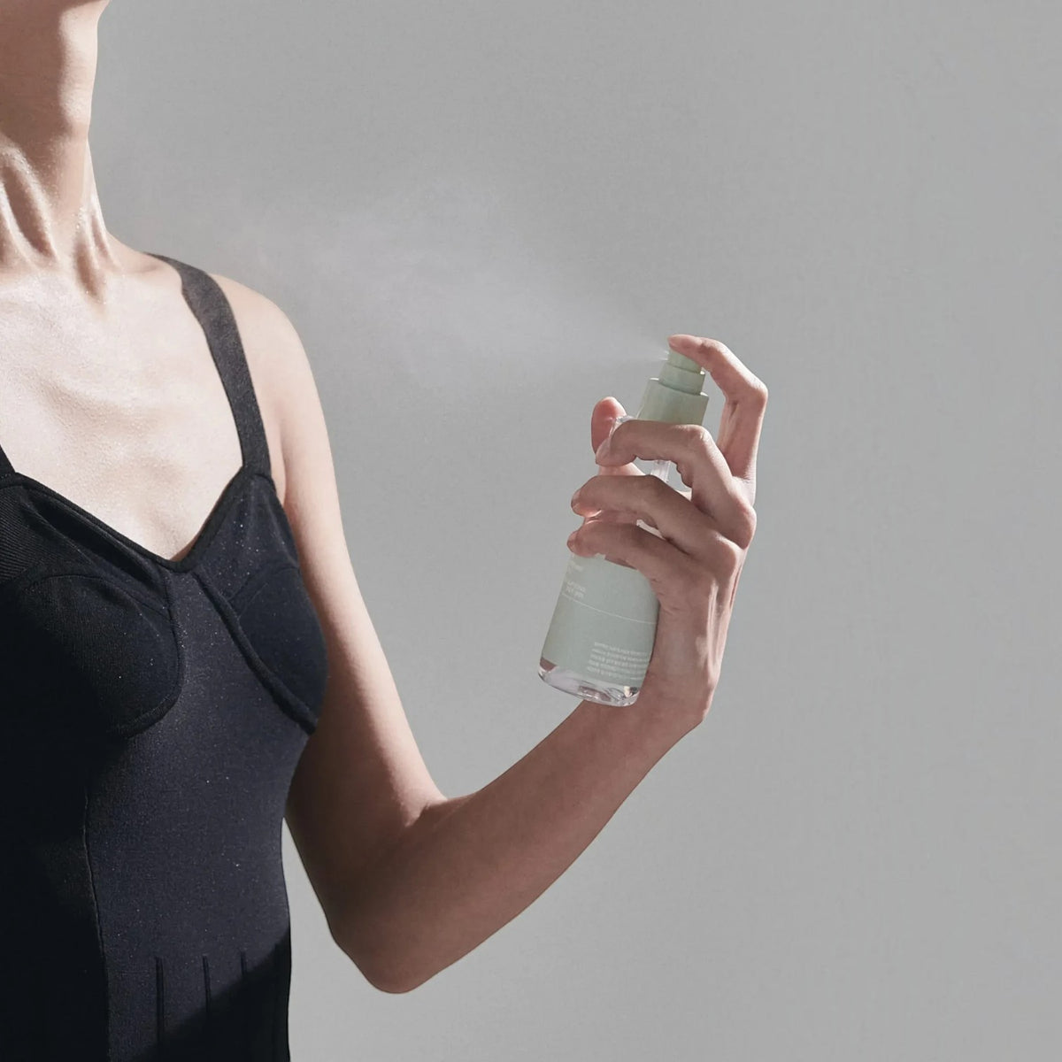 bareskin.lt Celimax Ji Woo Gae Heartleaf BHA body mist being sprayed onto a shoulder in a studio setting