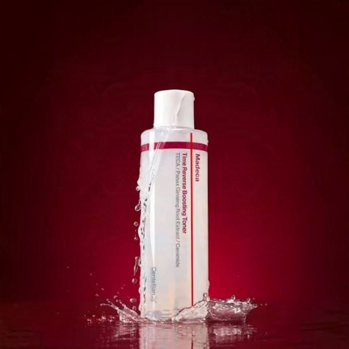 bareskin.lt Centellian24 Madeca Time Reverse Boosting Toner in a clear bottle with water splash on a red background