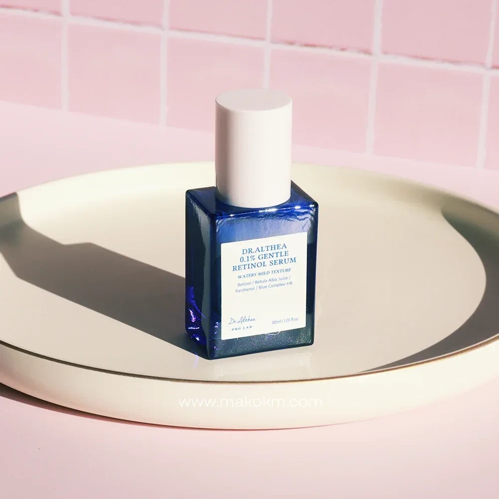 Dr.Althea 0.1 Gentle Retinol Serum in a blue glass bottle with a white cap on a beige tray from bareskin.lt