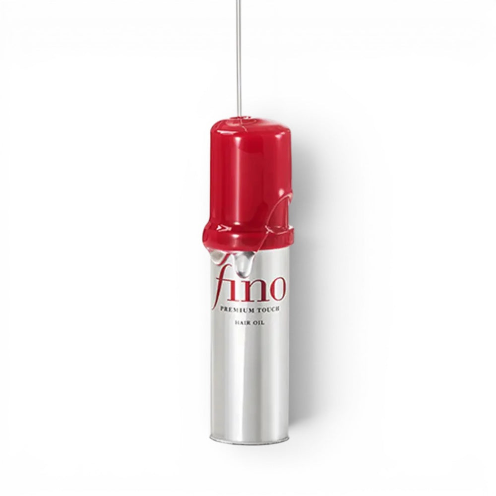 bareskin.lt Fino Premium Touch hair oil bottle with a red cap and clear oil dripping from the top