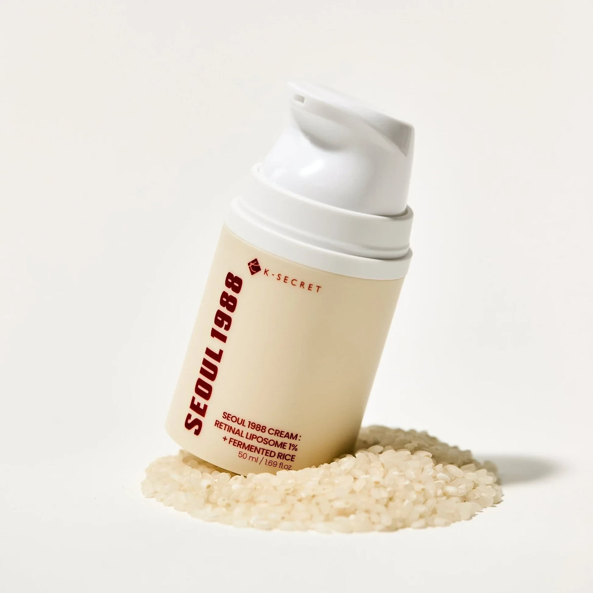 bareskin.lt KSECRET SEOUL 1988 Cream with retinal liposome and fermented rice in a beige pump bottle on rice grains