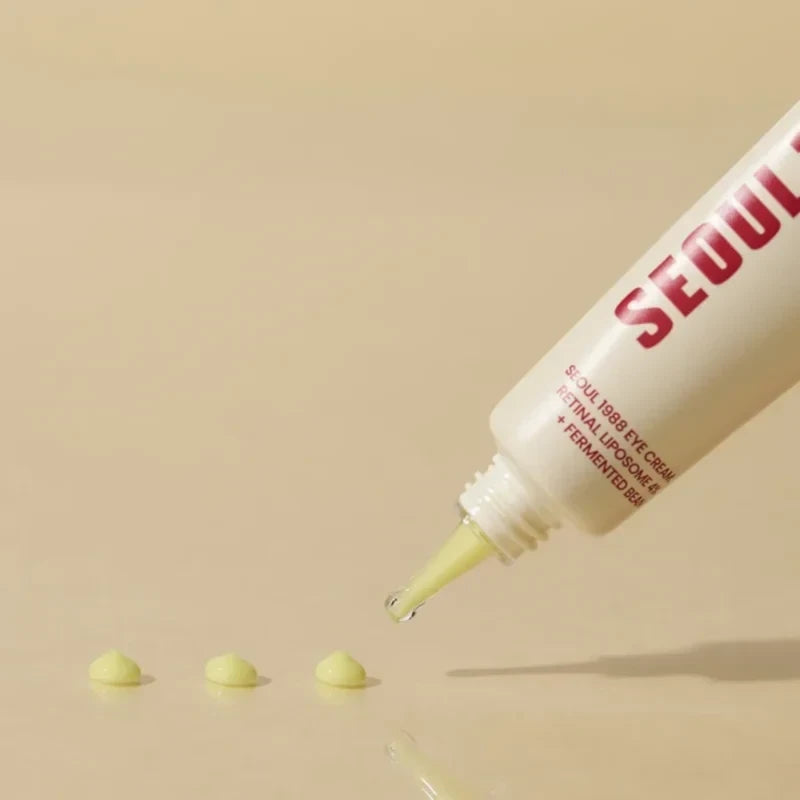bareskin.lt KSECRET SEOUL 1988 eye cream tube dispensing yellow retinal liposome cream onto a beige surface