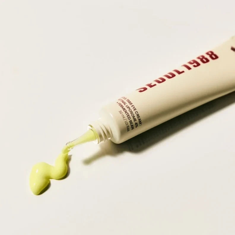 bareskin.lt KSECRET SEOUL 1988 eye cream tube dispensing a pale yellow retinal liposome formula on a white background
