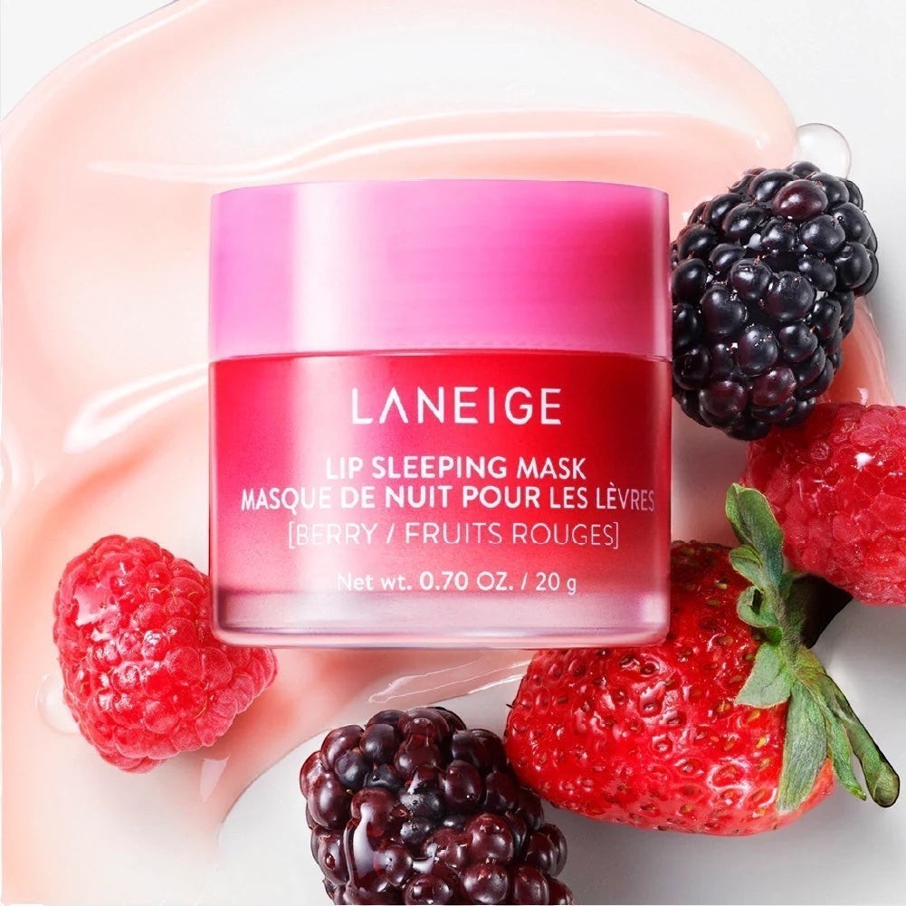 bareskin.lt LANEIGE Lip Sleeping Mask Berry in a pink jar surrounded by fresh strawberries, raspberries, and blackberries.