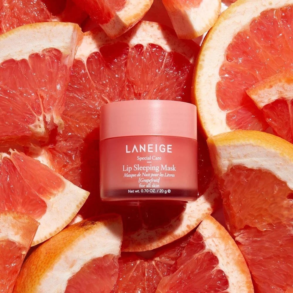 LANEIGE Lip Sleeping Mask in Grapefruit scent surrounded by fresh grapefruit slices, sold by bareskin.lt
