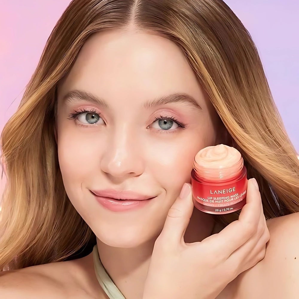 bareskin.lt LANEIGE Lip Sleeping Mask Berry in a small pink jar held by a woman with soft makeup
