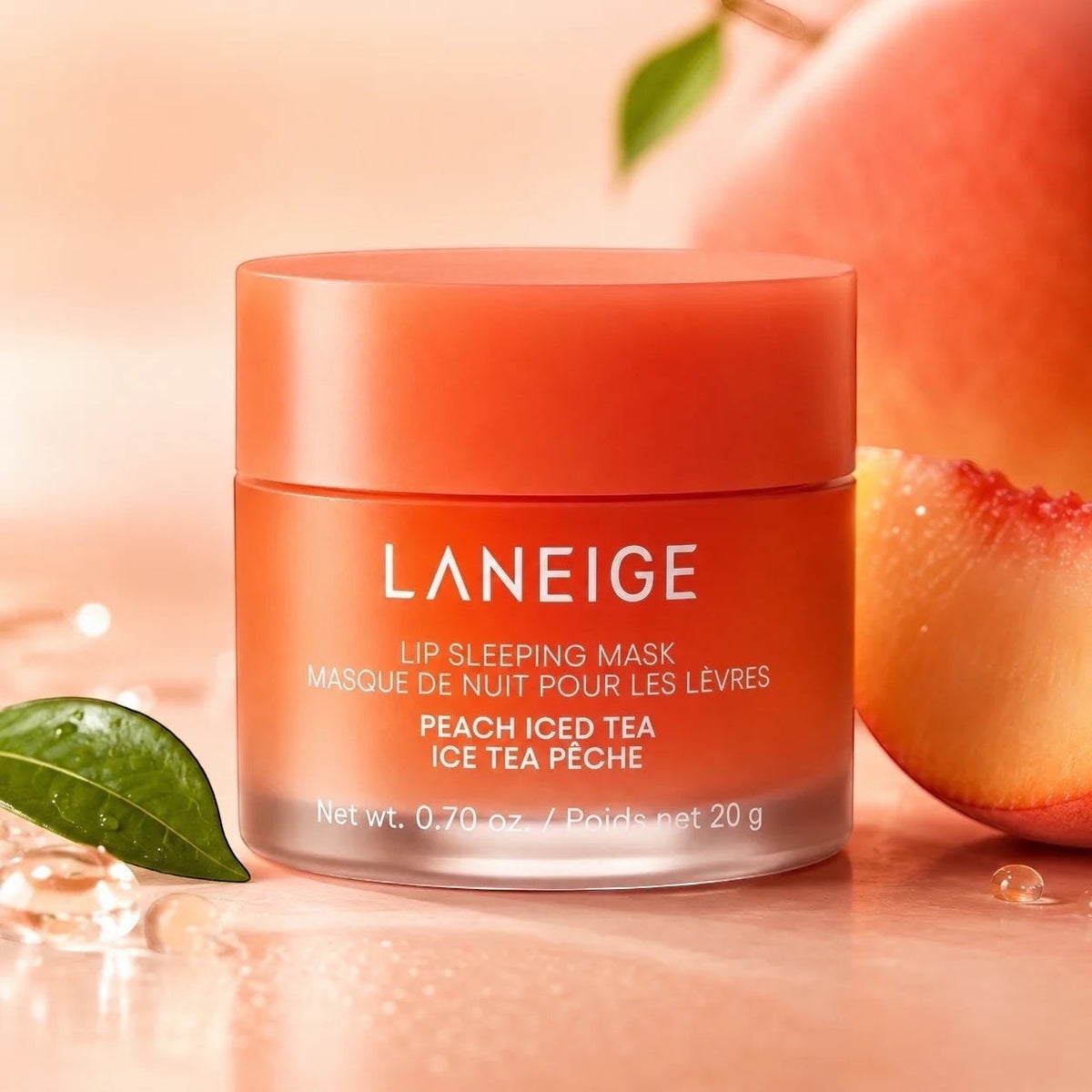 bareskin.lt LANEIGE Lip Sleeping Mask Peach Iced Tea in a peach-colored jar with fresh peach fruit and green leaves