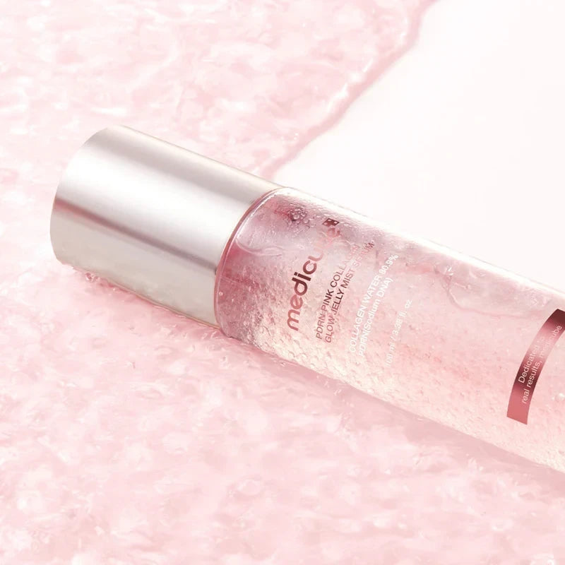 bareskin.lt Medicube PDRN Pink Collagen Glow Jelly Mist Serum in a clear bottle with pink liquid on a textured surface