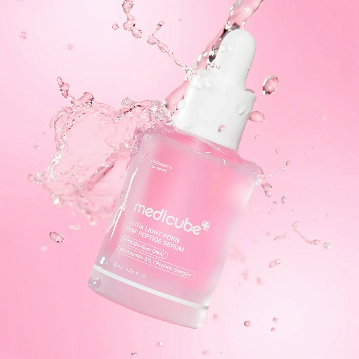 bareskin.lt Medicube Ultra Light PDRN Pink Peptide Serum bottle surrounded by refreshing water splashes on pink background