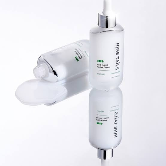 bareskin.lt Nine Tails Exo-Nano Revive Cream in a white bottle with a creamy texture spilled on a reflective surface
