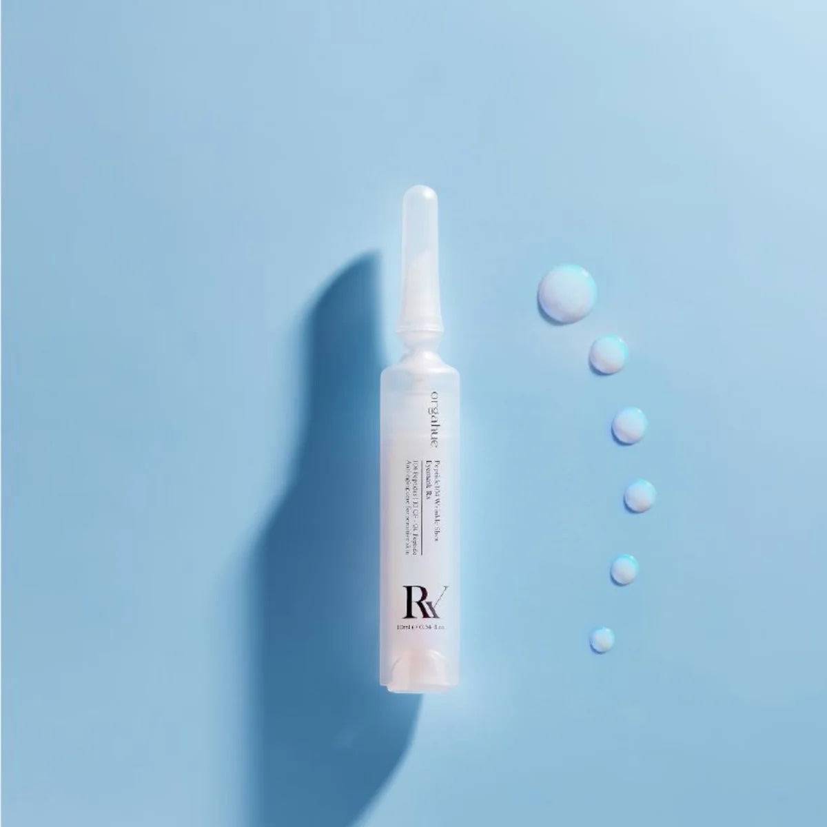 bareskin.lt orgahue Peptide 104 Wrinkle Shot Eyemask ampoule with serum droplets on a light blue background