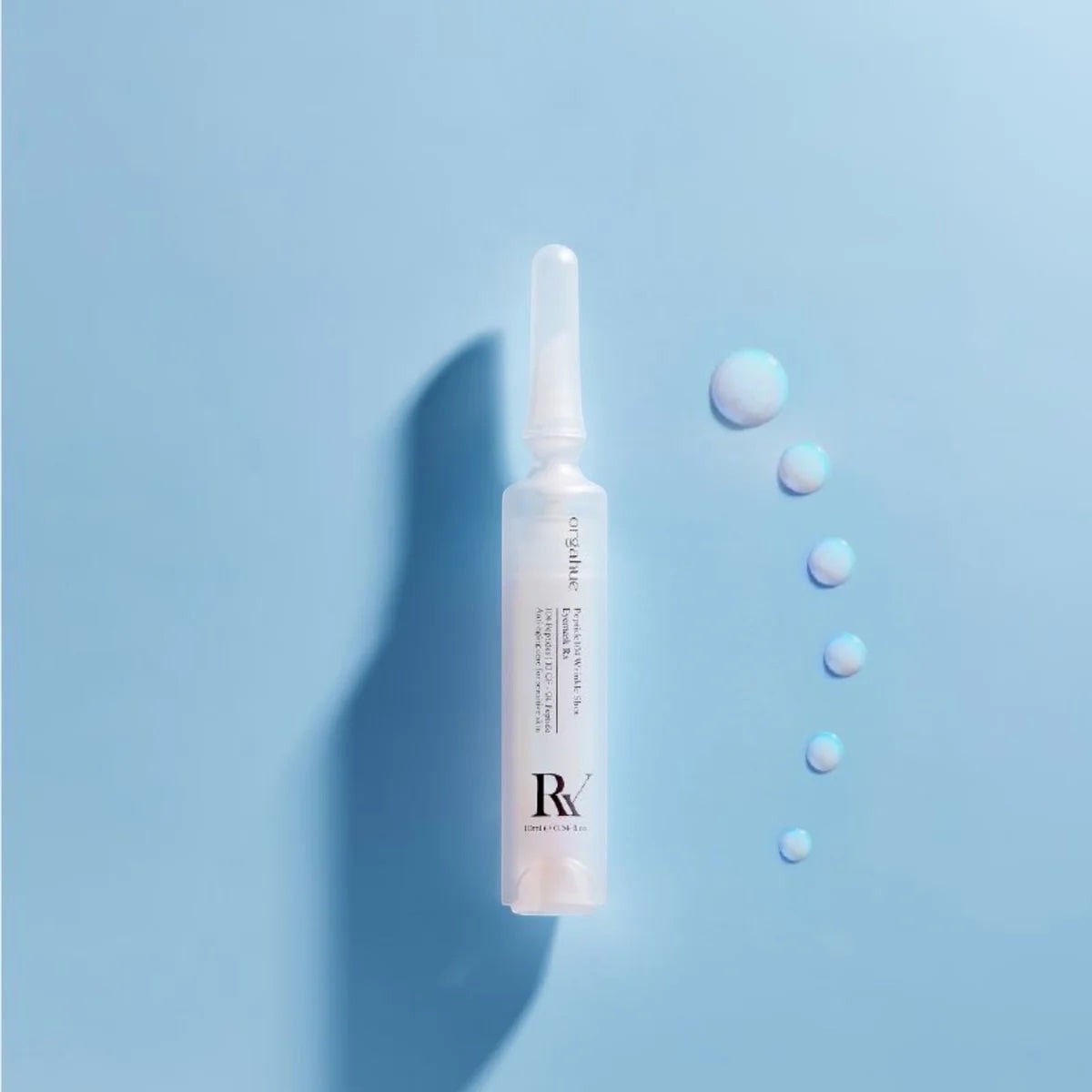 bareskin.lt orgahue Peptide 104 Wrinkle Shot Eyemask ampoule with serum droplets on a light blue background