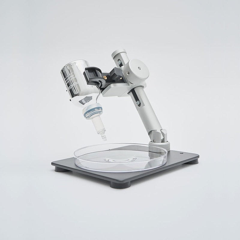 bareskin.lt PURCELL Pixcell Biom probiotic serum bottle mounted on a laboratory stand over a petri dish