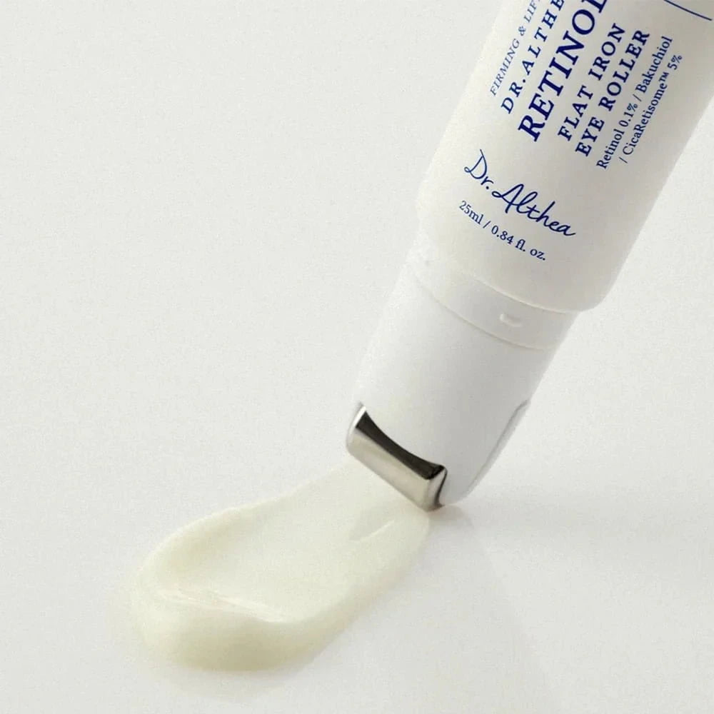 Dr. Althea Retinol Flat Iron Eye Roller from bareskin.lt with metal applicator dispensing white cream on white surface