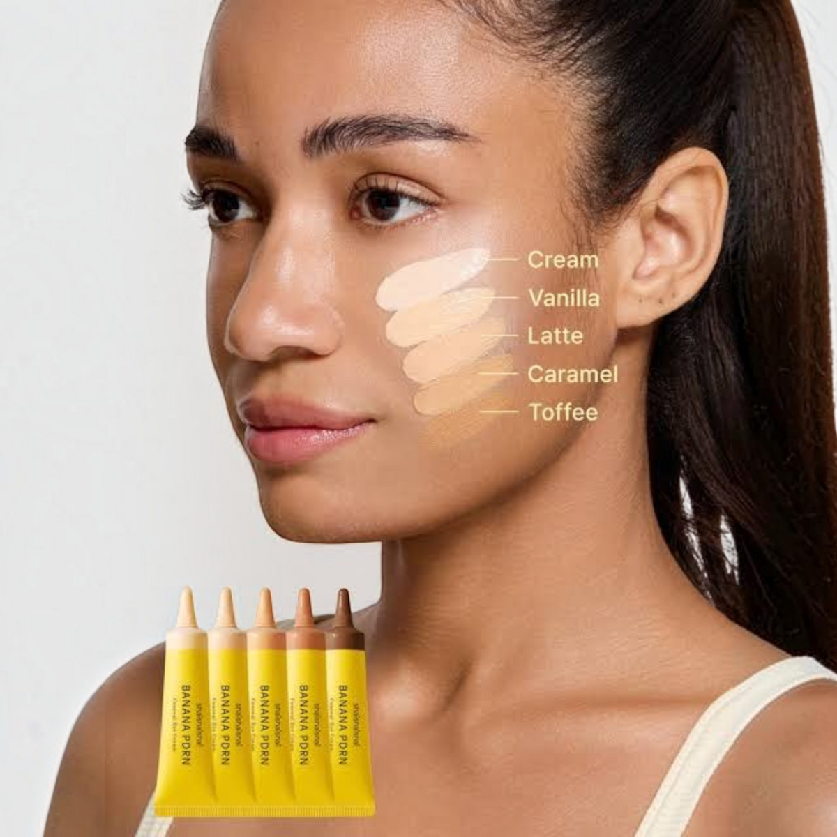 bareskin.lt shaishaishai Banana PDRN Conceal Eye Cream shades swatched on a model's cheek in Cream, Vanilla, Latte, Caramel, and Toffee.