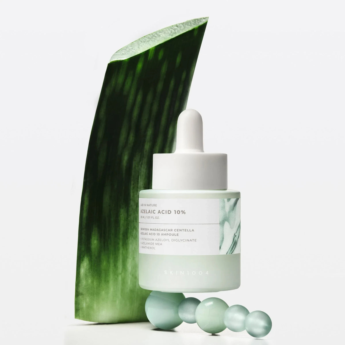 SKIN1004 Madagascar Centella Azelaic Acid 10 Ampoule by bareskin.lt with aloe vera leaf and glass spheres