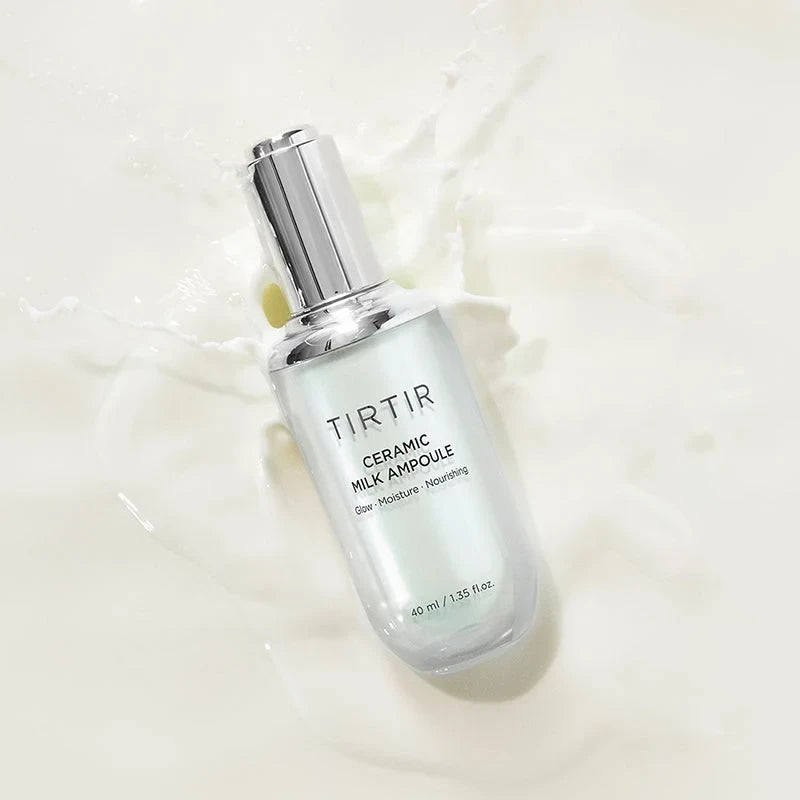 bareskin.lt TIRTIR Ceramic Milk Ampoule face serum in a glass bottle surrounded by a milky liquid splash