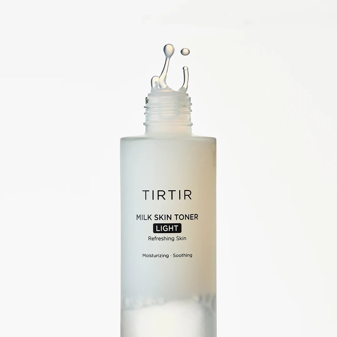 bareskin.lt TIRTIR Milk Skin Toner Light in a frosted glass bottle with a refreshing liquid splash on top
