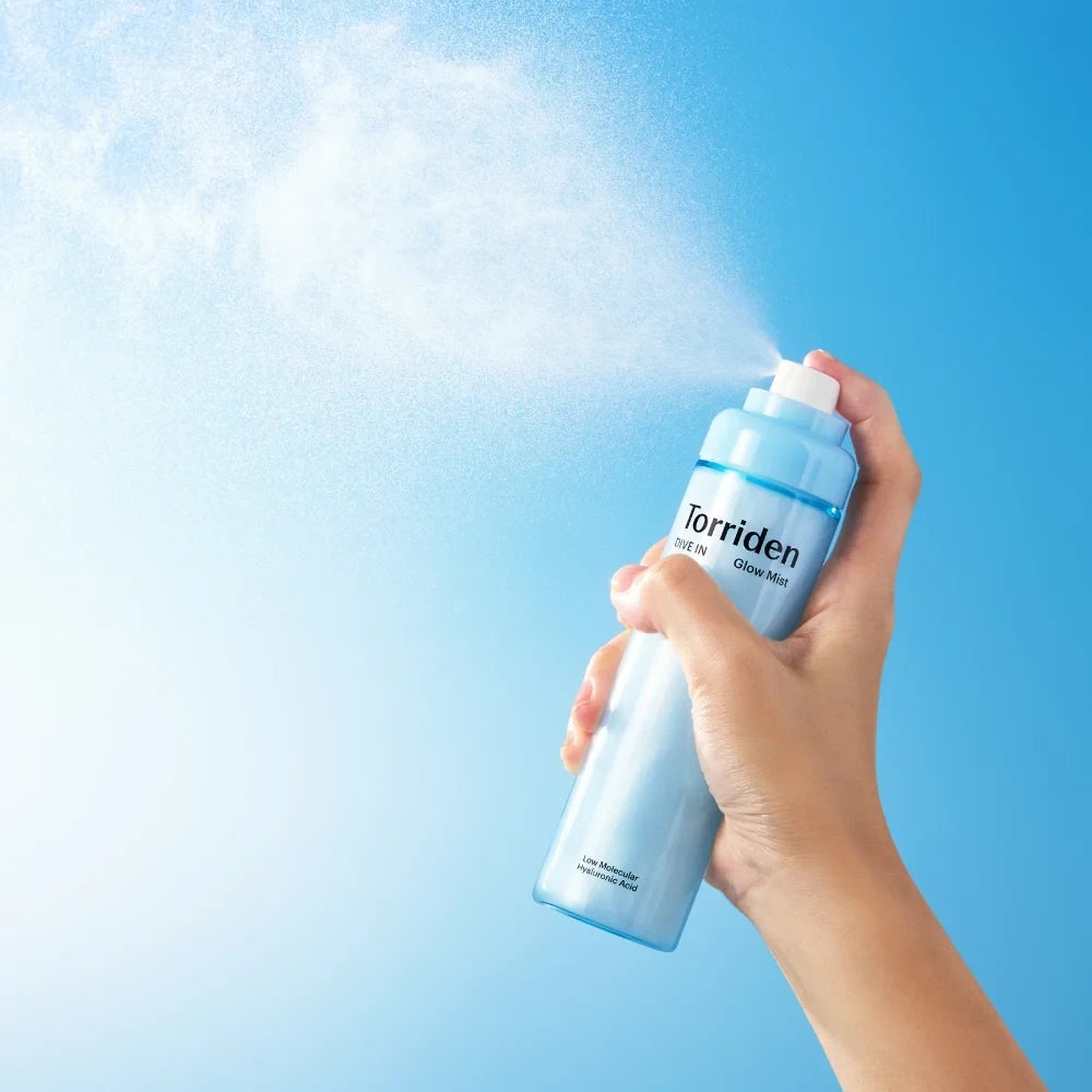 bareskin.lt Torriden Dive In Glow Mist facial spray being held and sprayed against a bright blue background
