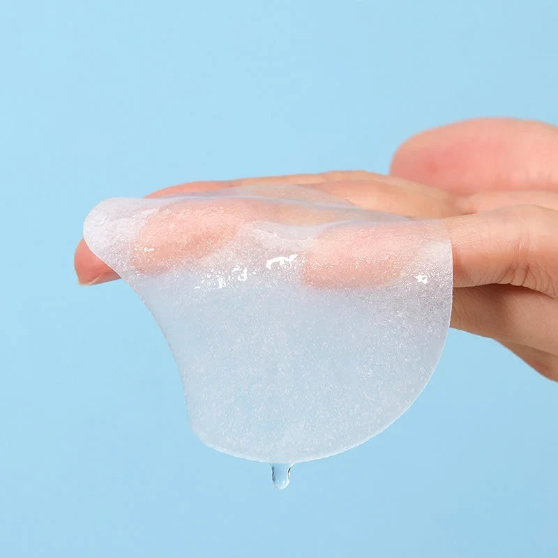bareskin.lt Torriden DIVE-IN hyaluronic acid essence pad held on a finger, showing a thin, moist, translucent texture.