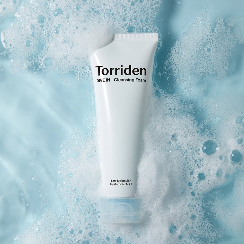 Torriden DIVE IN Hyaluronic Acid Cleansing Foam from bareskin.lt in a white tube surrounded by soft soap bubbles