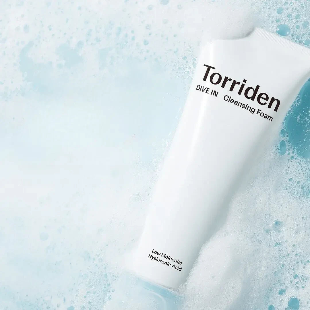 bareskin.lt Torriden DIVE IN hyaluronic acid cleansing foam tube surrounded by soft white bubbles on a blue background