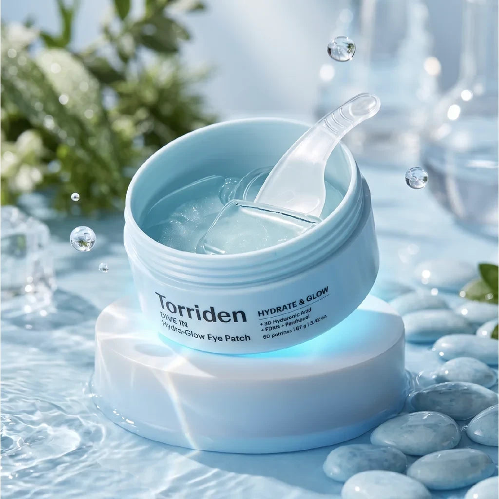 bareskin.lt Torriden Dive In Hydra-Glow eye patches in a light blue jar with a spatula, set on a stone in water.
