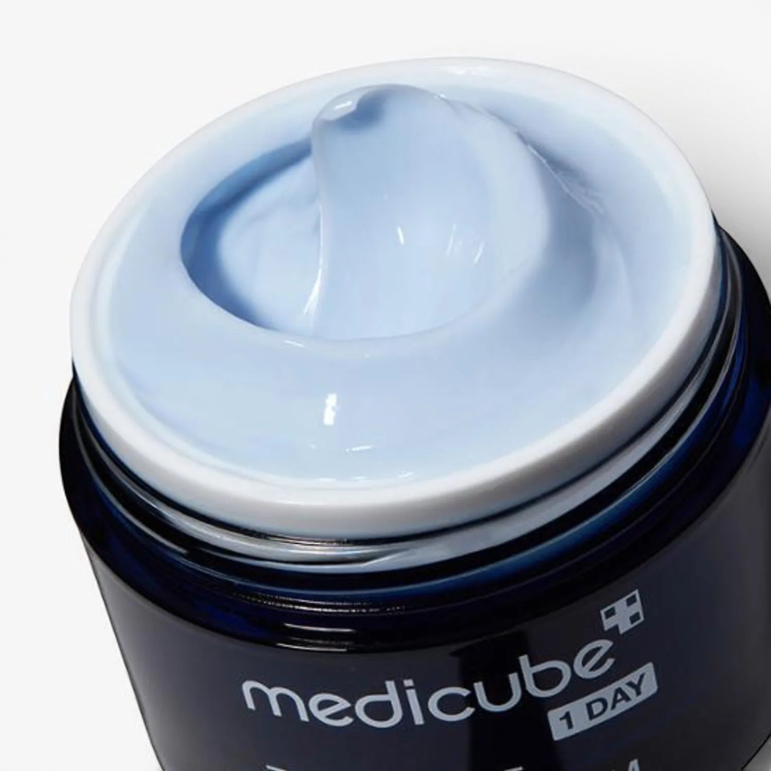 Medicube Zero Pore One Day Cream in a dark blue jar from bareskin.lt, featuring a light blue hydrating face cream.