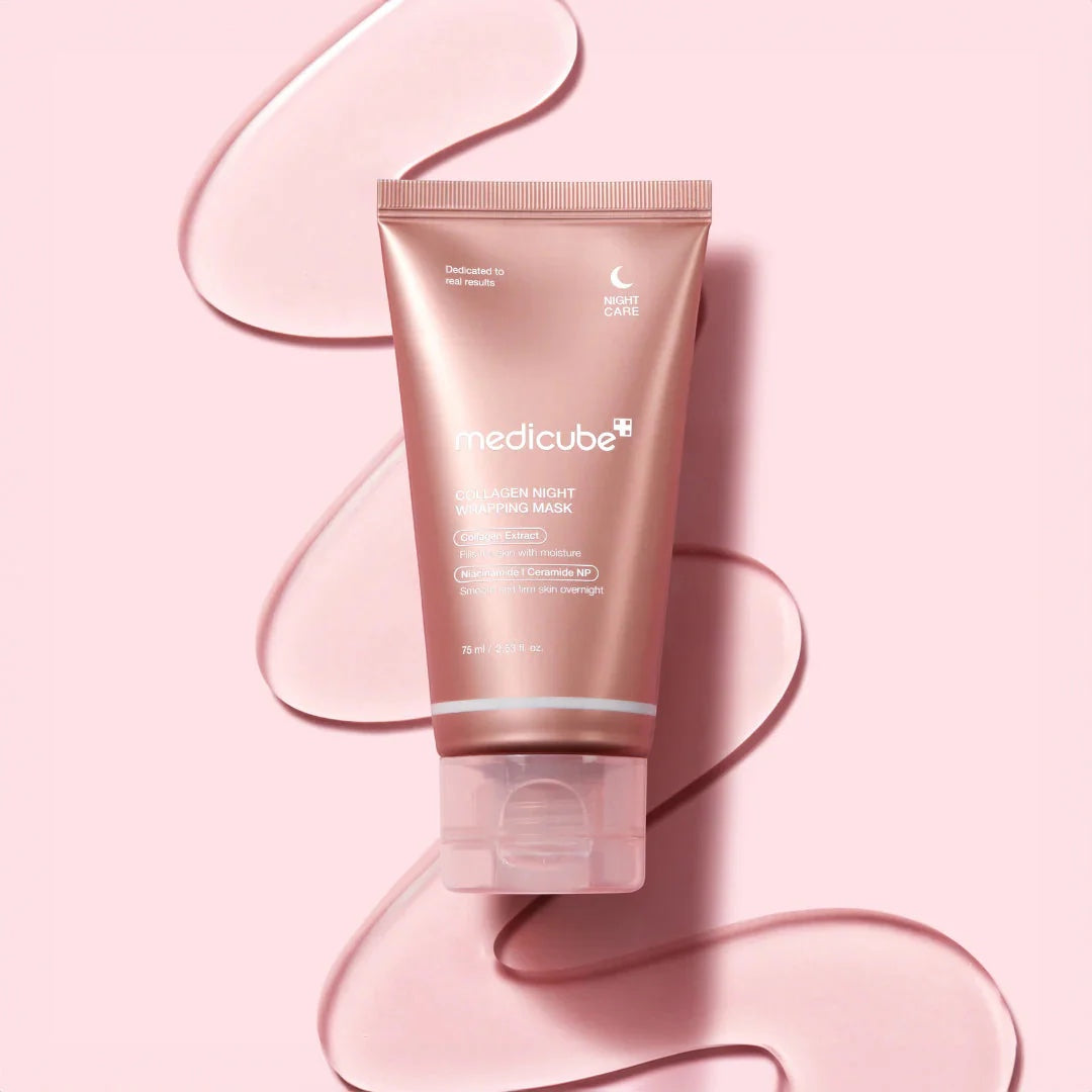 Medicube Collagen Night Wrapping Mask from bareskin.lt in a rose gold tube on a pink background with cream swirls.