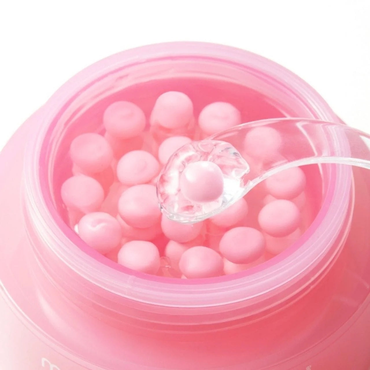 Medicube PDRN Pink Collagen Capsule Cream in a jar with a clear spatula from bareskin.lt for firming and hydration.